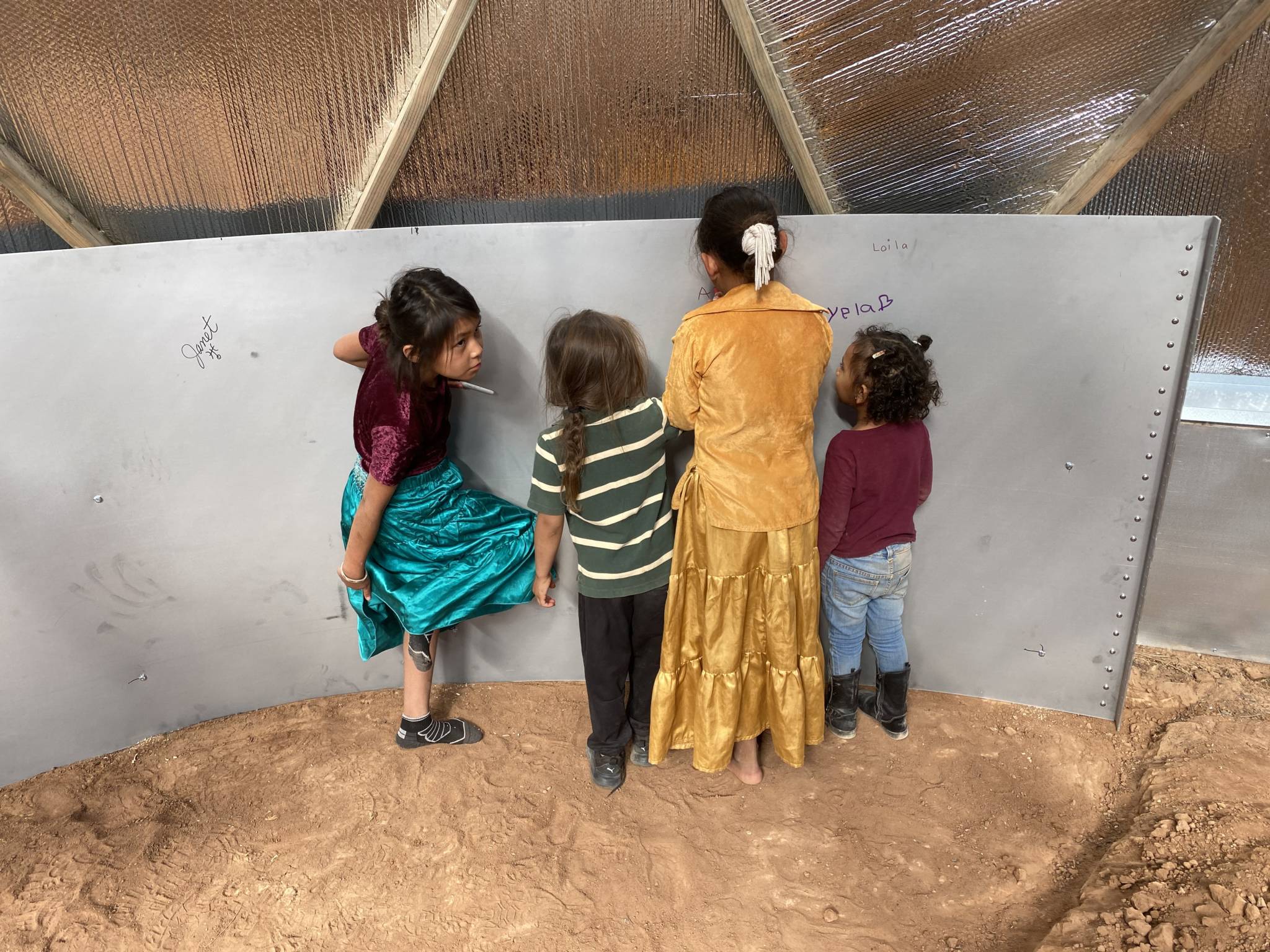 Kids signing above ground pond