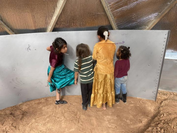Kids signing above ground pond