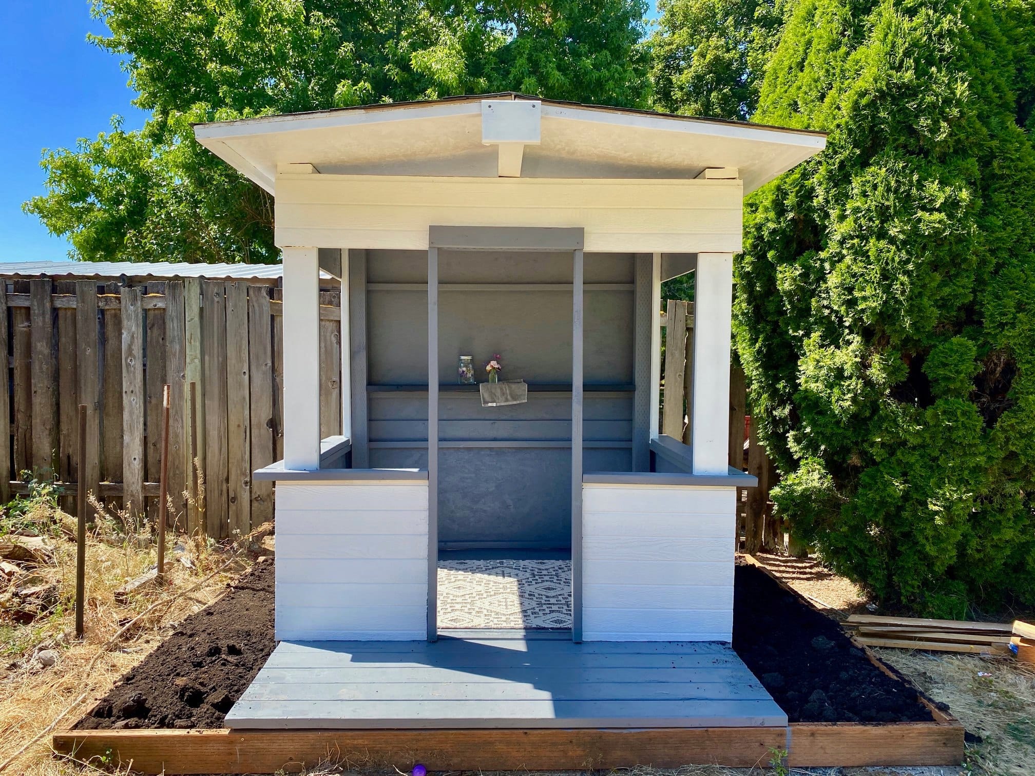 White and gray playhouse made from recycled shipping materials