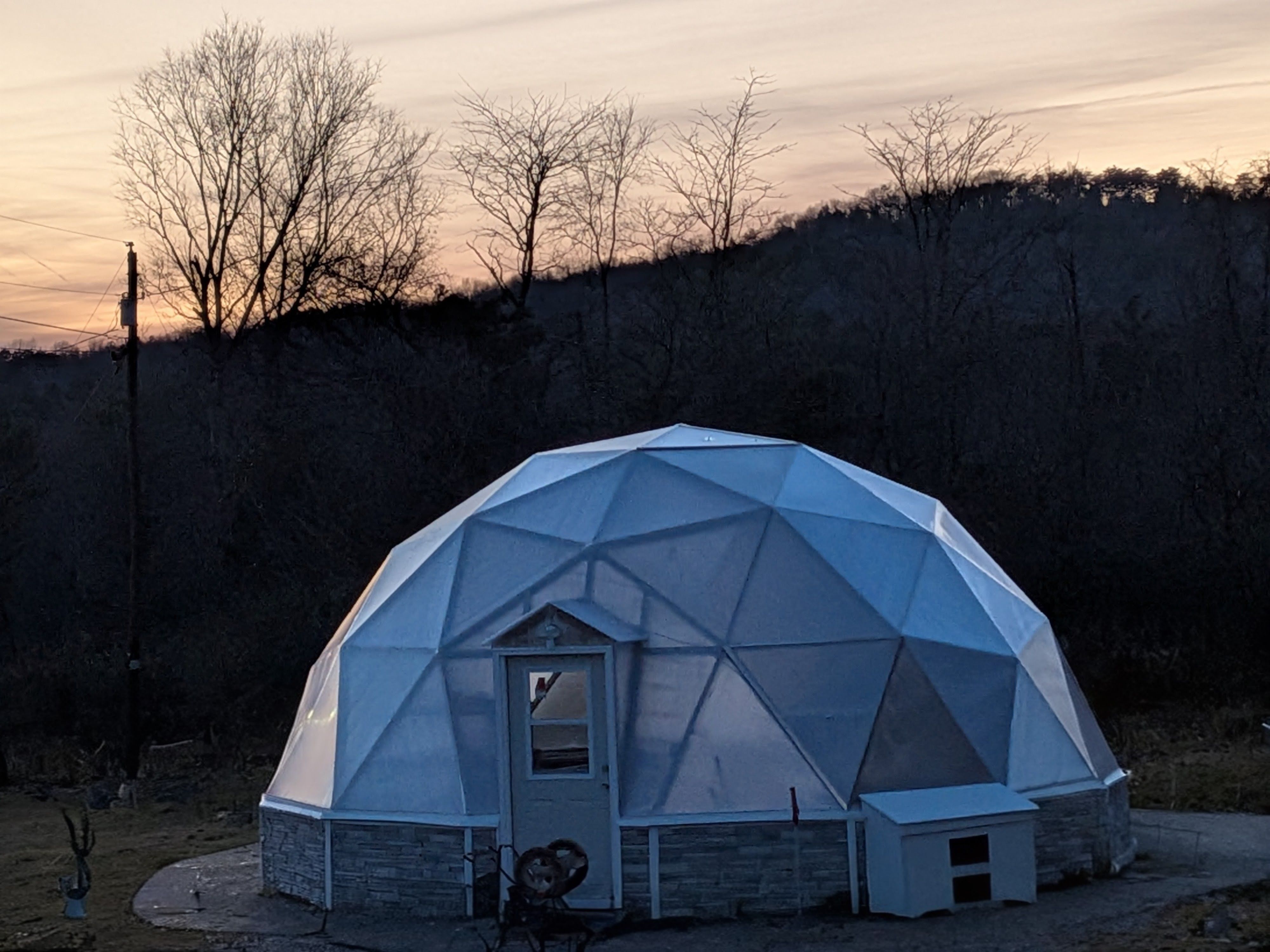 Growing Dome greenhouse with ICF foundation at dusk