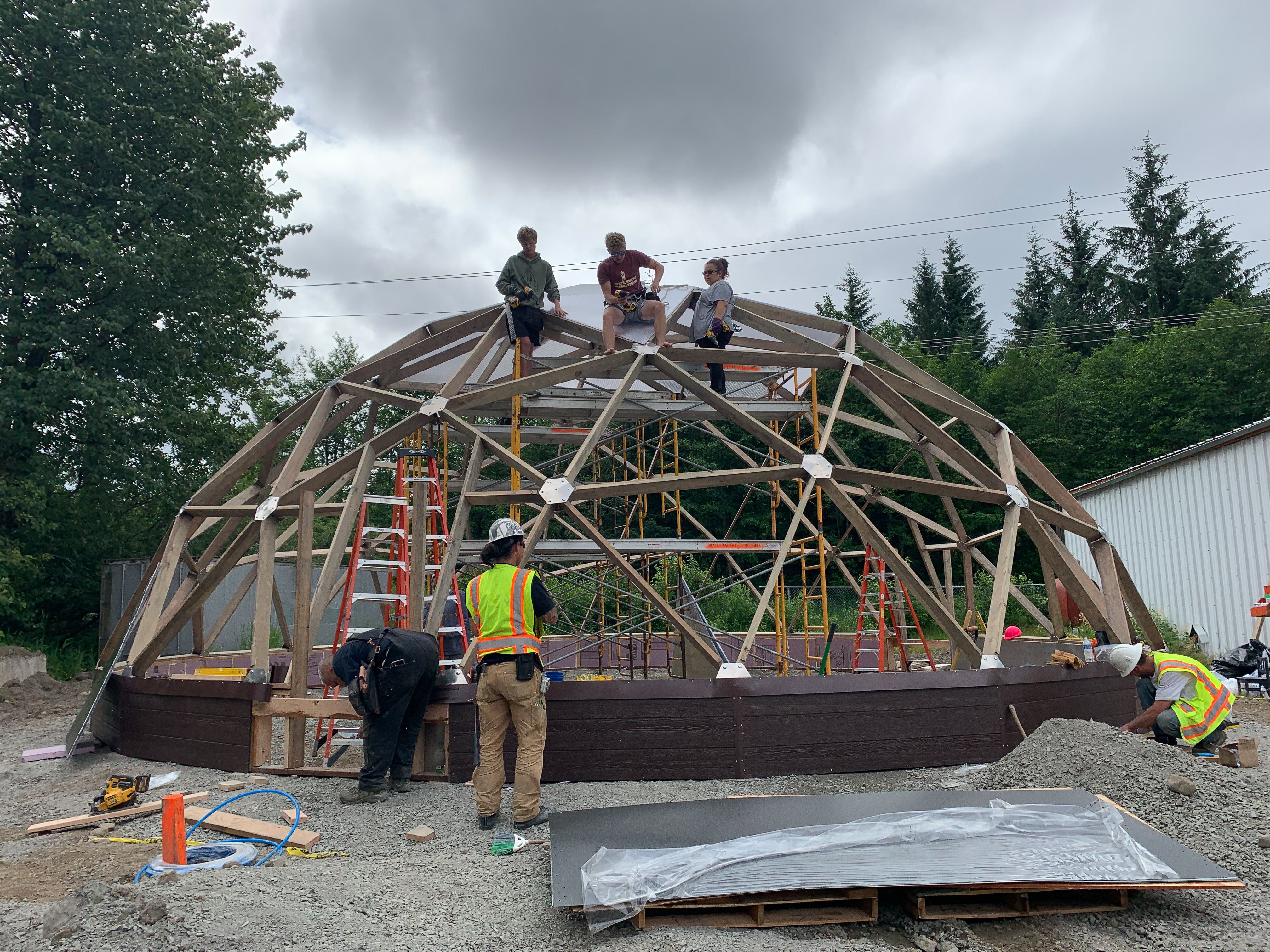 Construction crew building a geodesic dome in Alaska