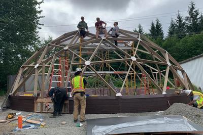 Construction crew building a geodesic dome in Alaska