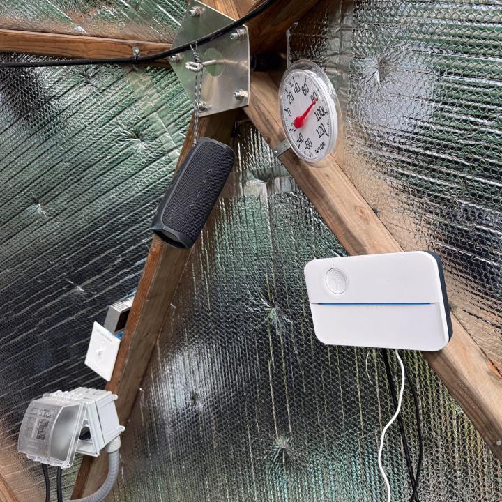A control module mounted to a wooden strut in a Growing Dome and a wireless speaker