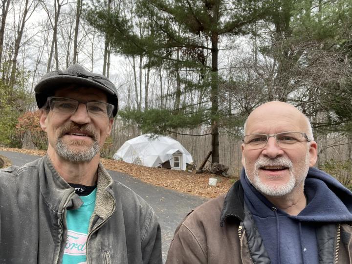 Allen Nedam and fellow engineer Bruce with the Growing Dome greenhouse in the background