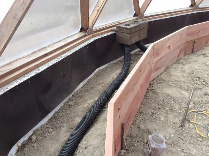 Undersoil fans mounted to foundation wall