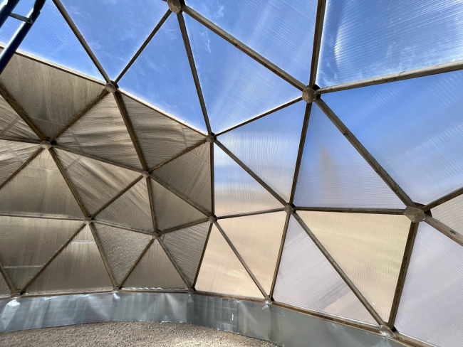 Geodesic Dome greenhouse with wooden struts, reflective insulation, and polycarbonate