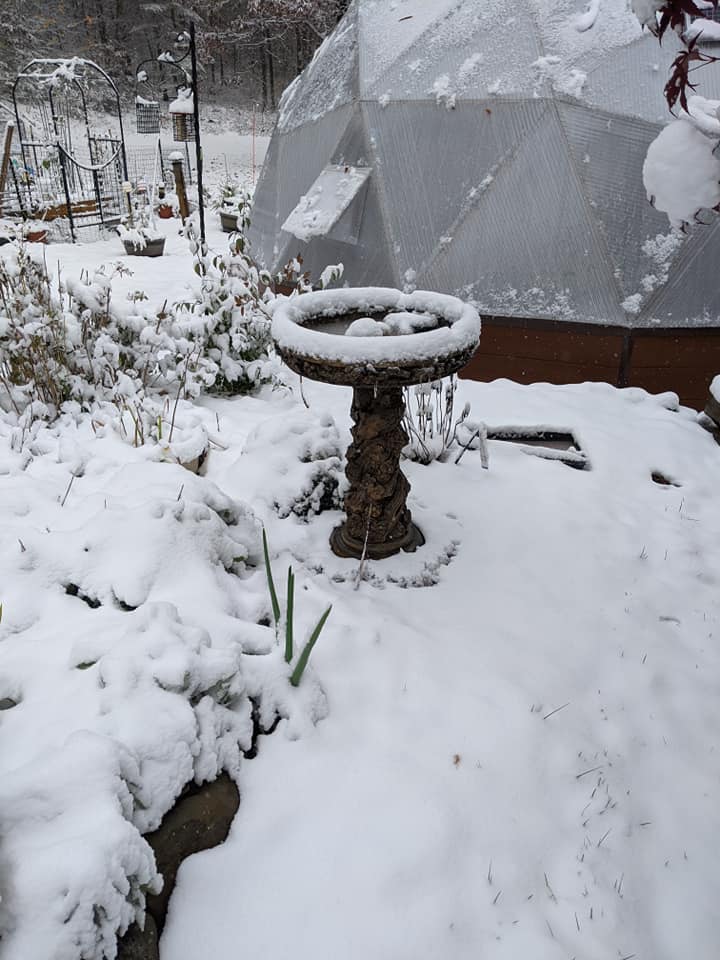 snow covered bird bath near New Hampshire growing dome greenhouse