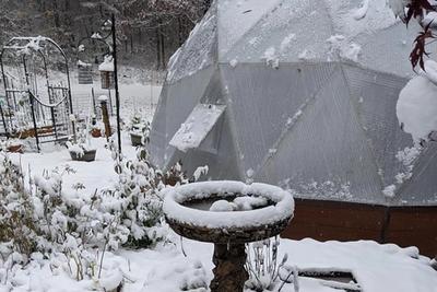 snow covered bird bath near New Hampshire growing dome greenhouse