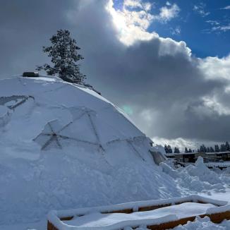 42' Growing Dome with snow building along the north wall to insulate and keep the greenhouse warm