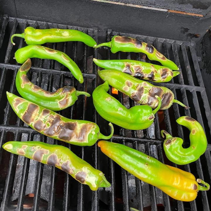 green chile that have been flipped on the grill and have charred marks