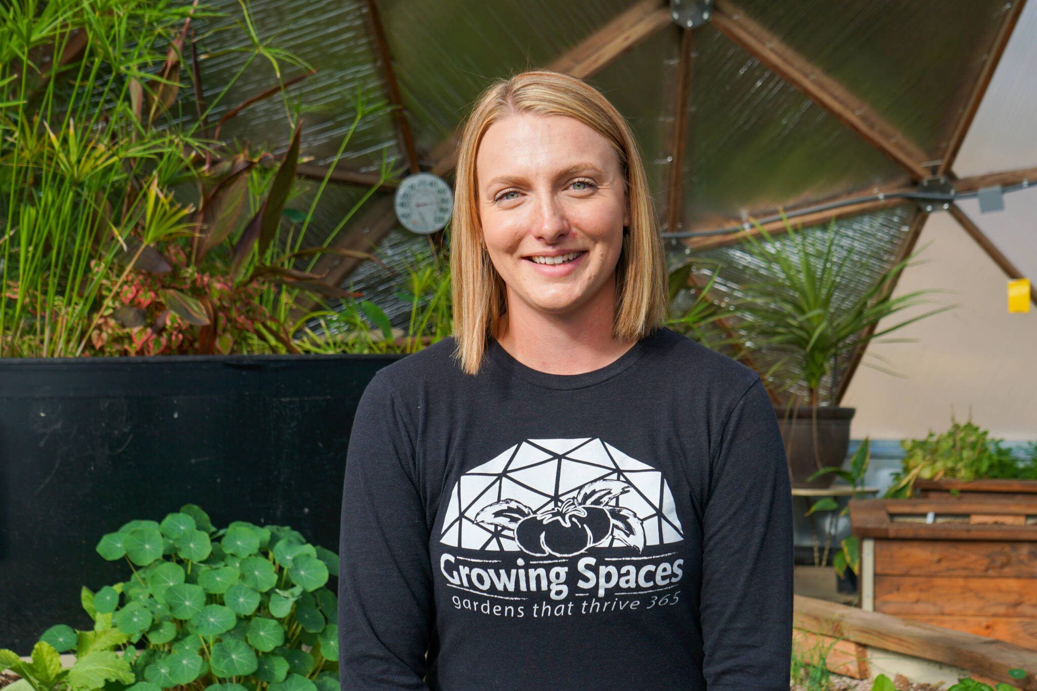 Portrait of Growing Spaces' Marketing Manager, Shelby Lucero, inside a 33' Growing Dome