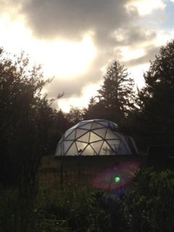 22' Growing Dome Greenhouse at Green Angel Gardens in Long Beach, WA during a blue cloudy humid