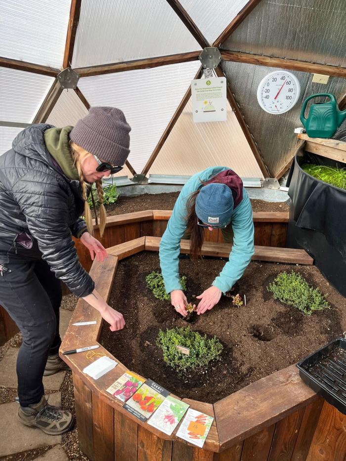 growing spaces employees planting in a 15' growing dome