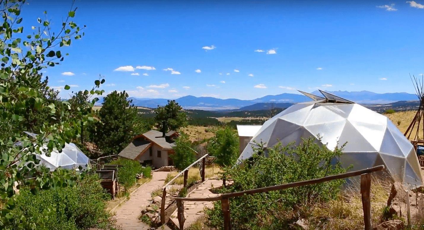 off grid greenhouses with a mountain view