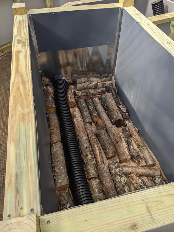 Hugelkultur in Growing Dome Greenhouse with logs