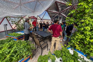 community group learning in a growing dome greenhouse