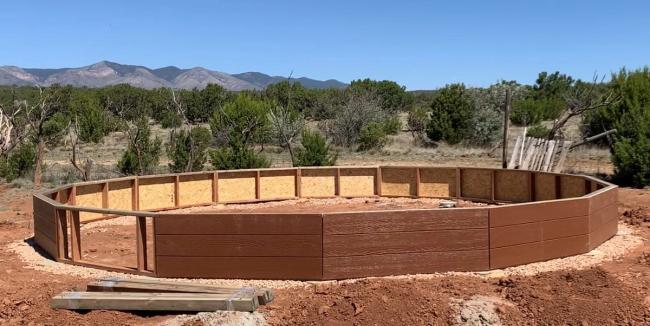 framed foundation wall for the greenhouse with siding added