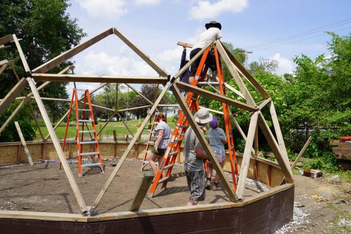 Volunteers attaching Growing Dome struts to hubs