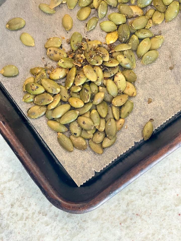 roasted peptias pumpkin seeds for the pesto pasta salad  on a baking sheet