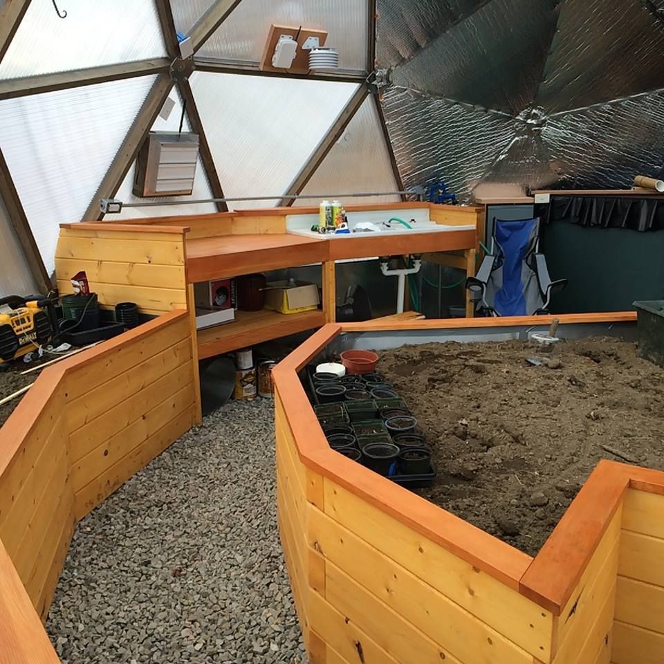 Growing dome greenhouse with a built in potting bench and workstation