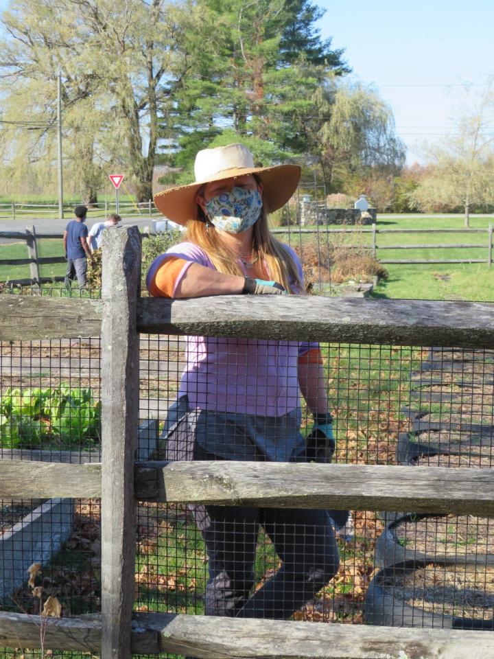 student farming outside school greenhouse
