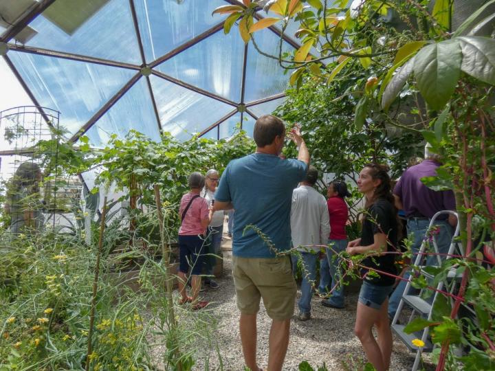 Man and Women Inside Growing Dome having a conversation