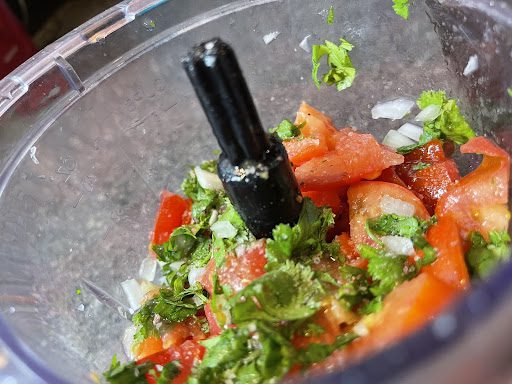 cilantro onions and tomatoes in a food processor