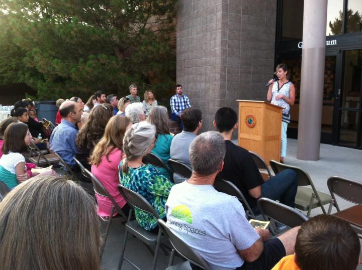people sitting in front of a podium at Littleton Academy greenhouse celebration ceremony