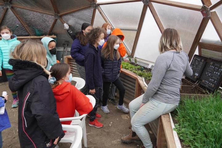 Students learning about urban agriculture in a Growing Dome greenhouse