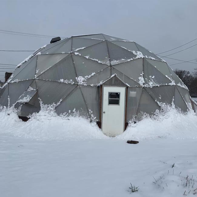 Community growing dome covered in snow
