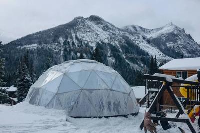 Growing Dome greenhouse in the Montana mountains covered in frost