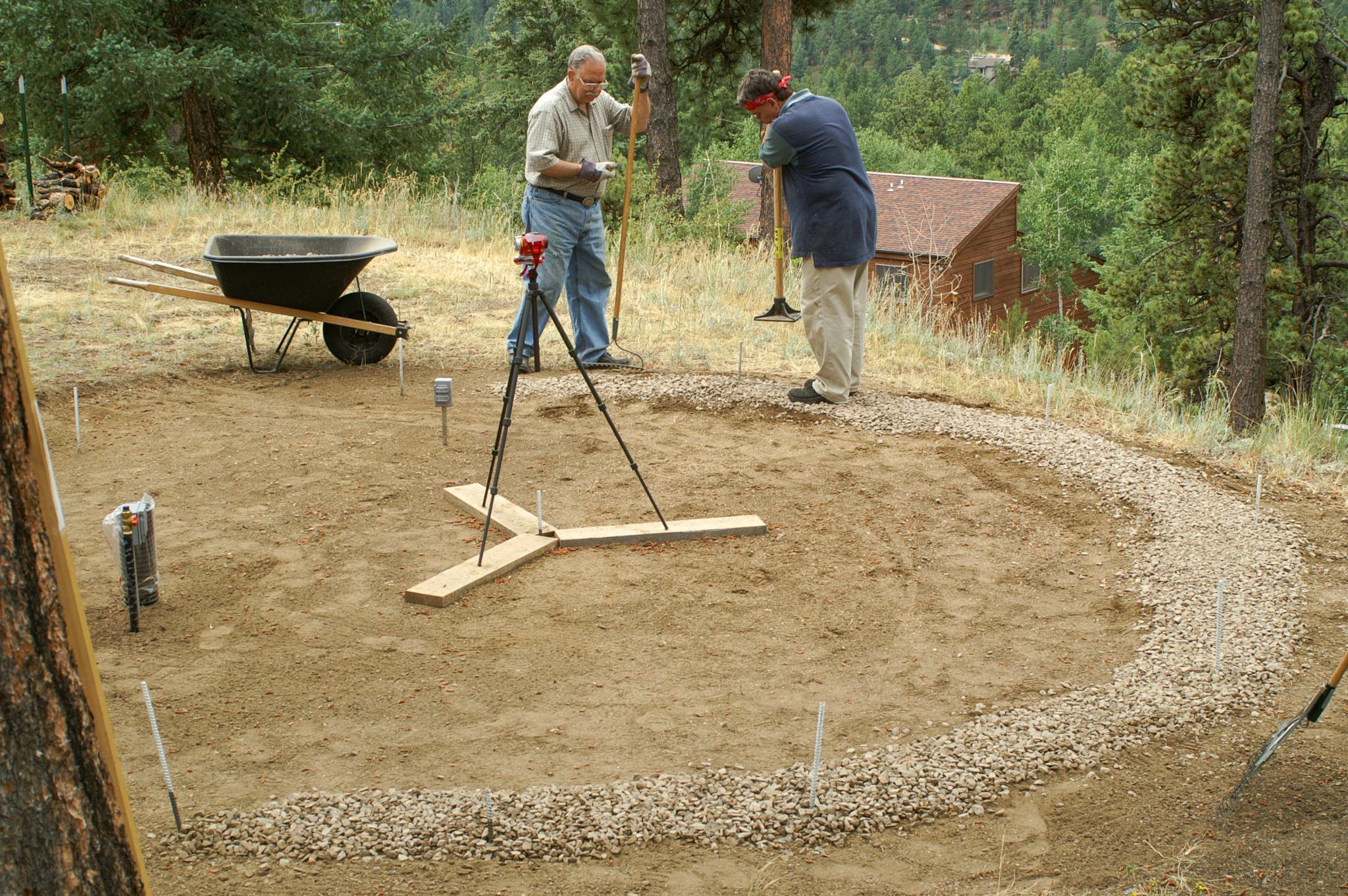 two men leveling and compacting a gravel ring foundation