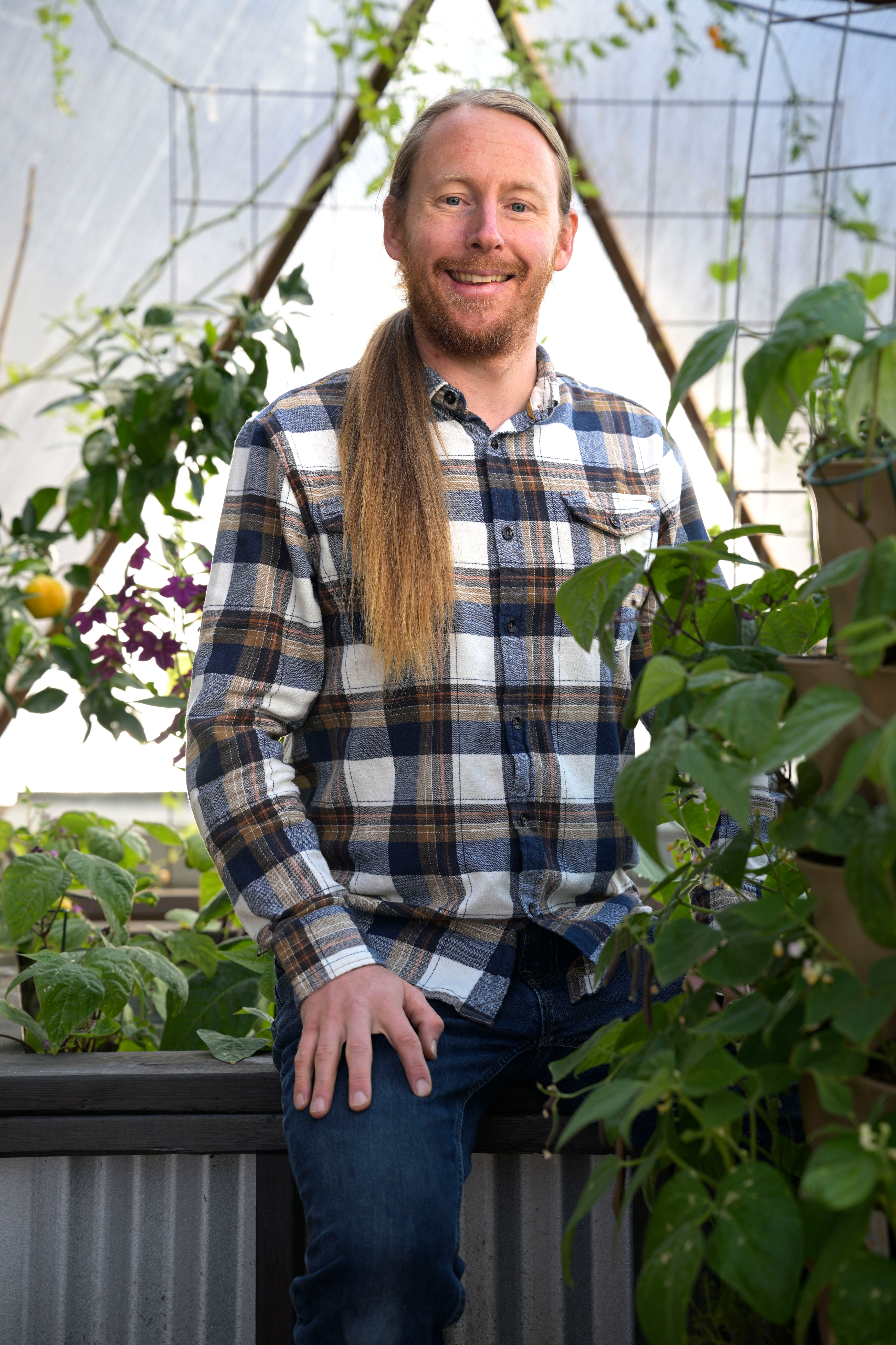 Portrait of Growing Spaces' Customer Experience Manager, Kyle Brookens, inside a 33' Growing Dome