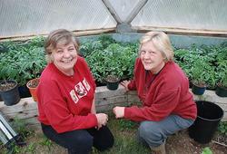 two women (barbra and danielle) inside a growing dome greenhouse garden