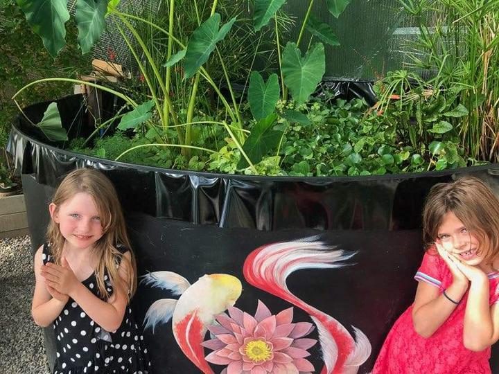 girls by pond