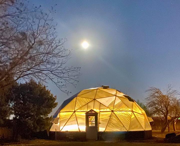 Growing Dome illuminated in the evening light under a full moon