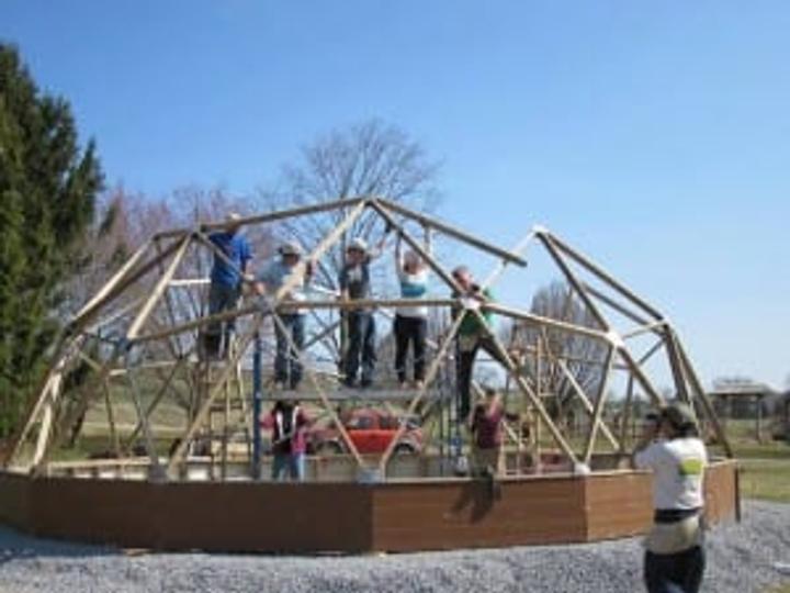 Volunteers assembling a Growing Dome greenhouse