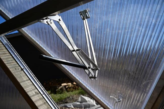 univent installed on the bottom vent of a greenhouse