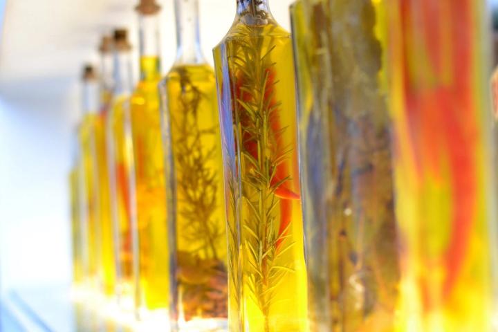 bottles of herbs and peppers in oil