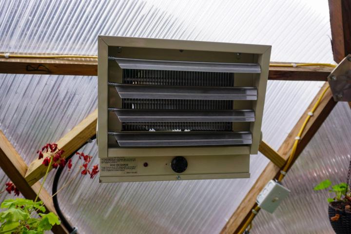 electric heater hung on greenhouse wall
