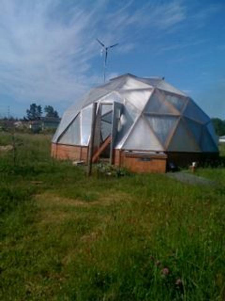 22' Growing Dome Greenhouse at Green Angel Gardens in Long Beach, WA during a blue sky day.