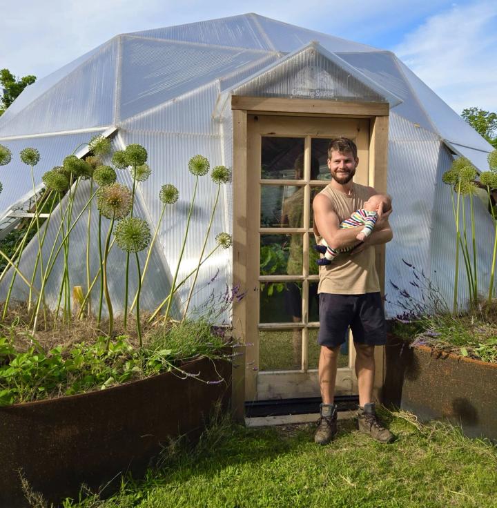 Ben Barkan and his son outside a Growing Dome greenhouse