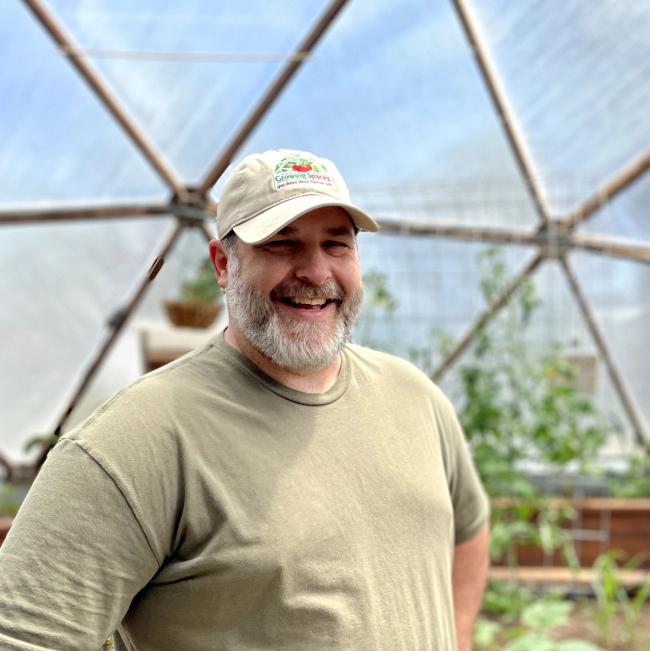 Portrait of Growing Spaces' Chief Executive, Gary Hall, inside a 33' Growing Dome