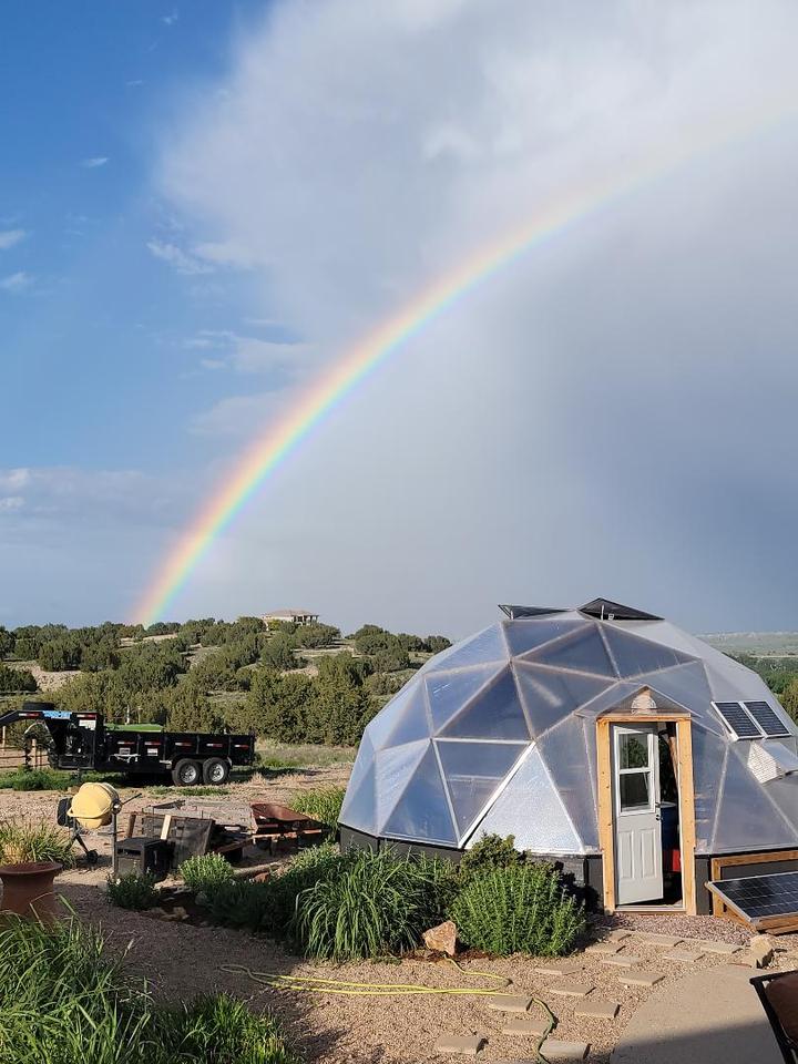 Growing Dome Greenhouse with rainbow in the sky.