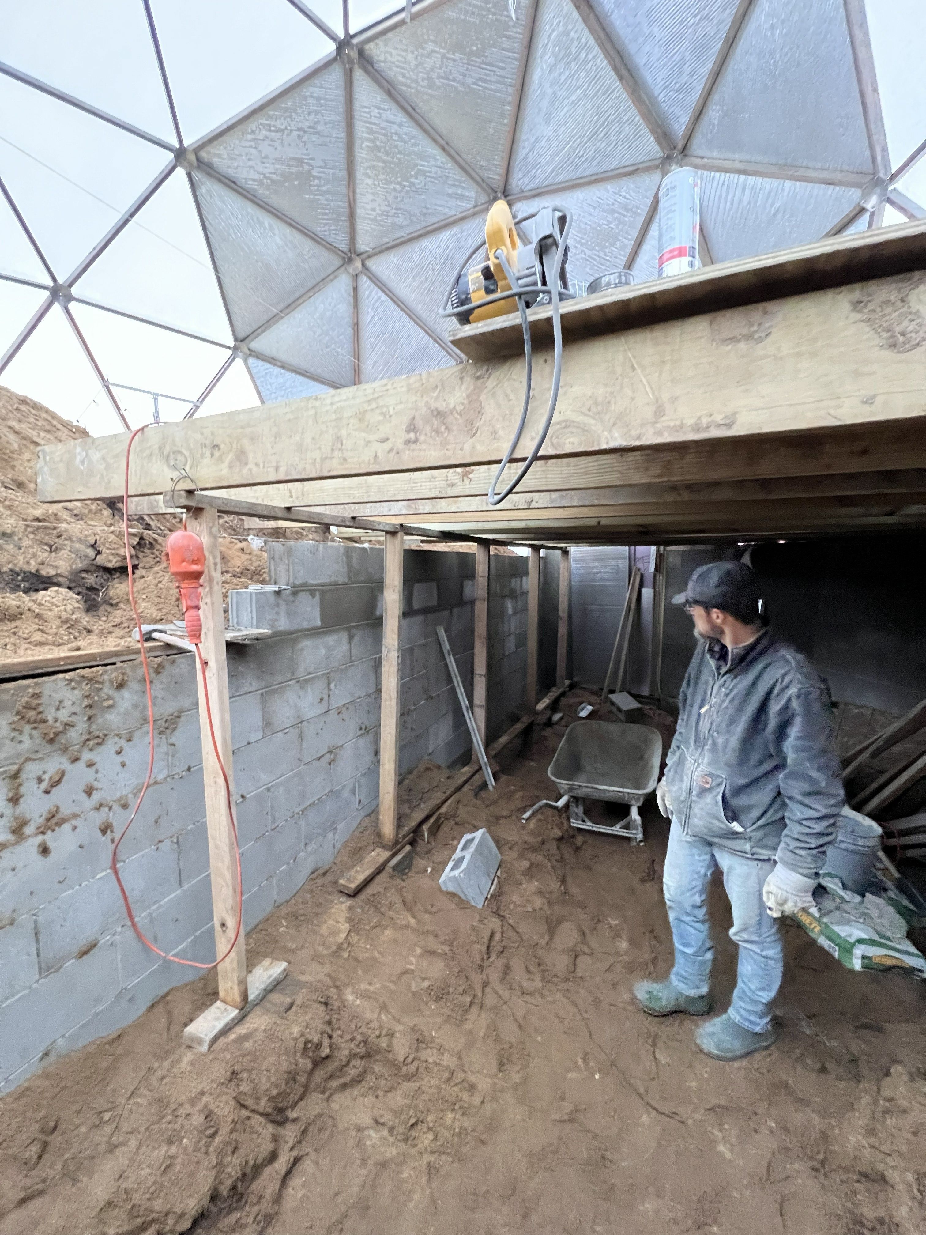 Custom basement walls beneath the Nedams' Growing Dome frame during construction