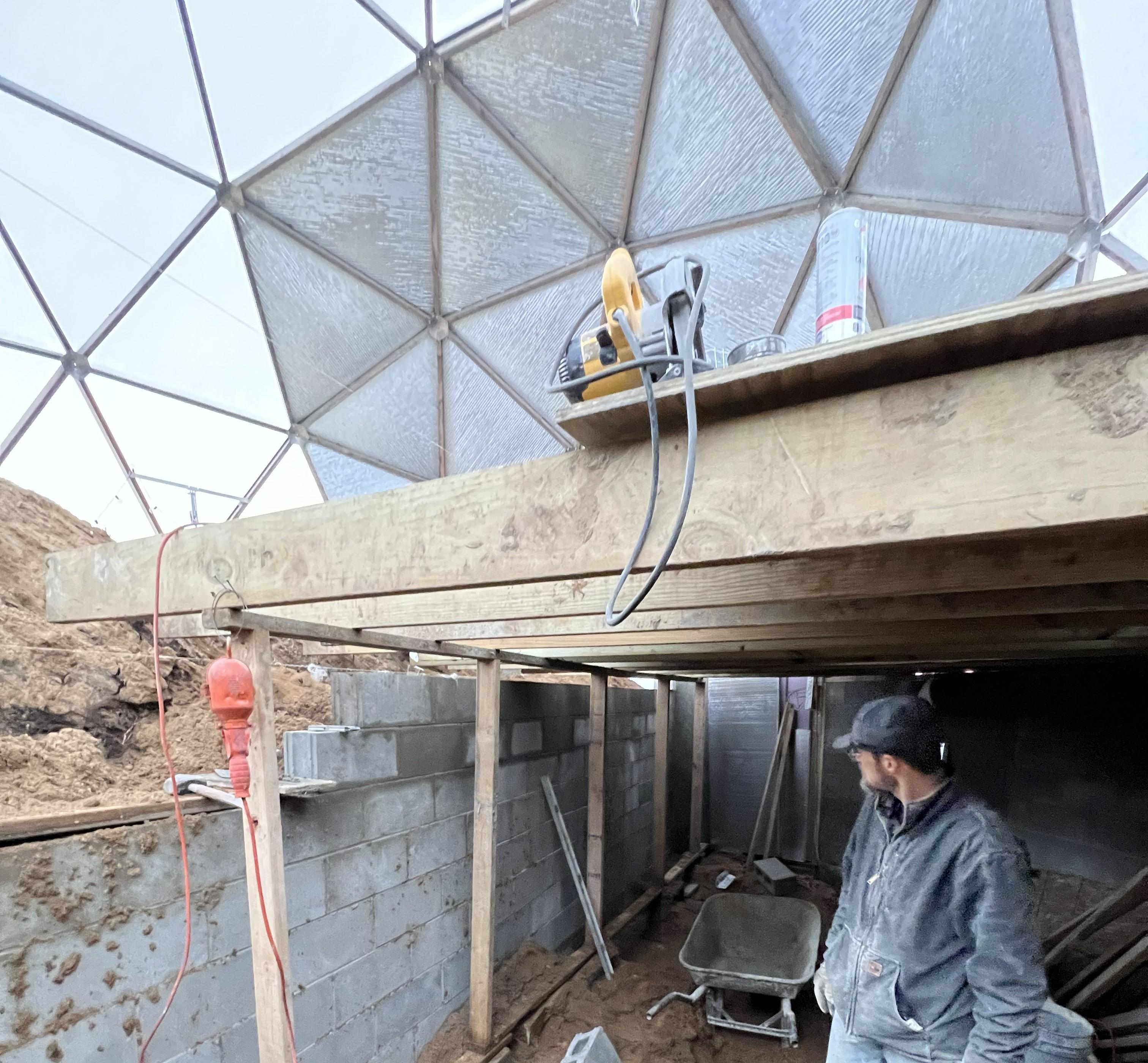 Custom basement walls beneath the Nedams' Growing Dome frame during construction