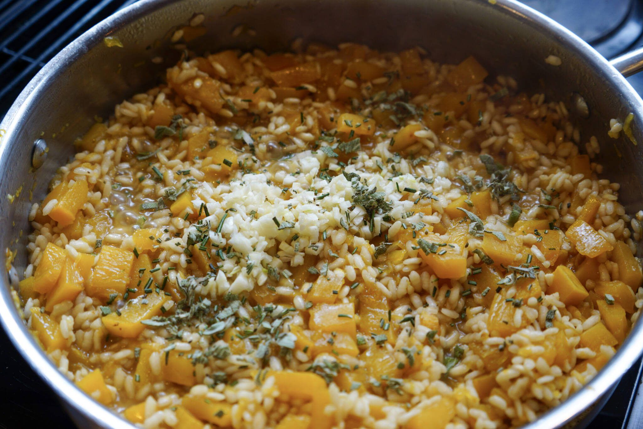 adding spices to pumpkin squash risotto
