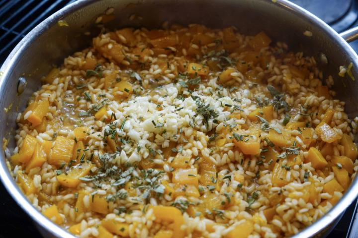 adding spices to pumpkin squash risotto