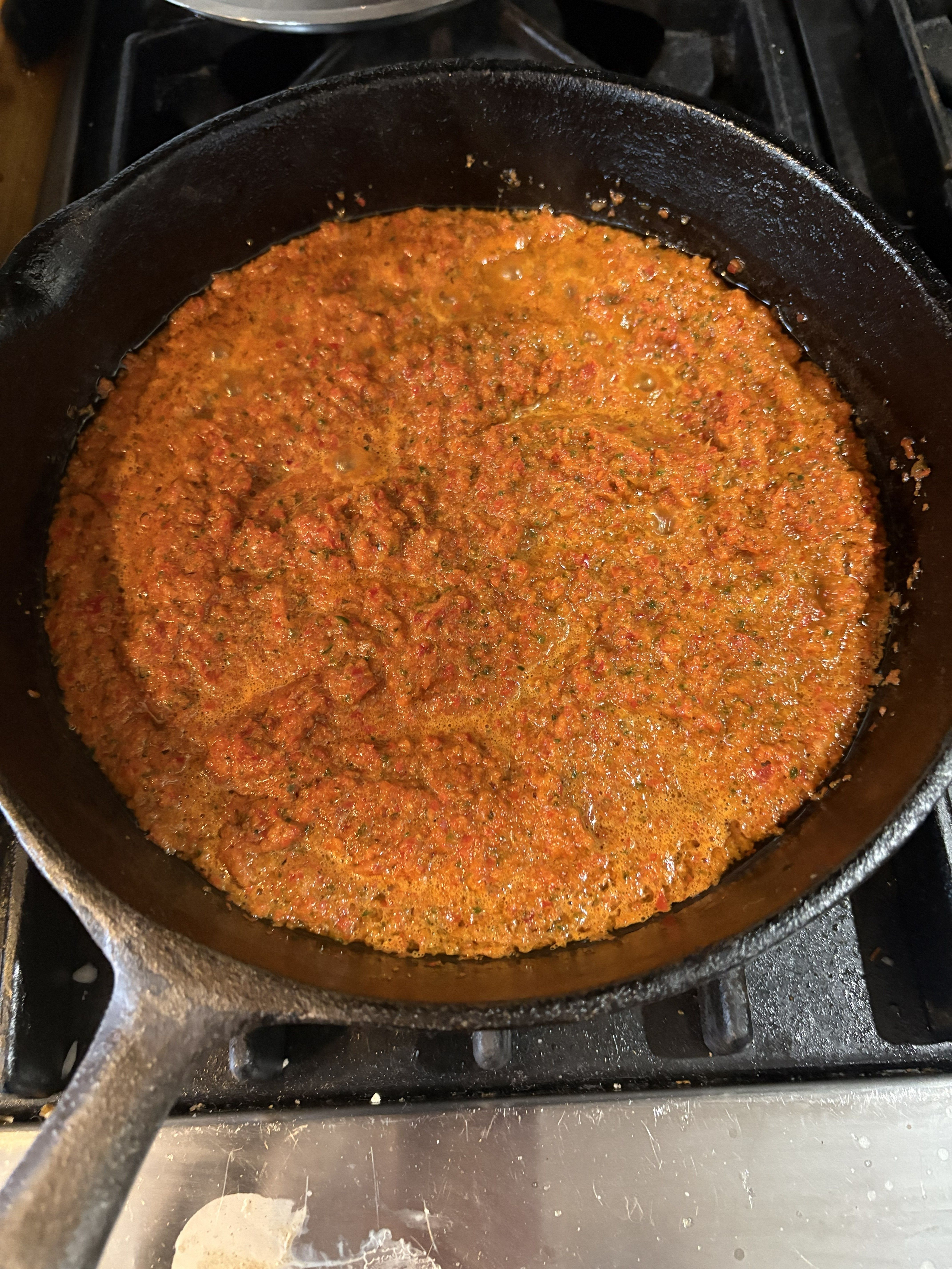 cooking the pepper puree in a castiron skillet