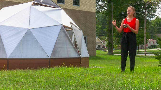 Woman standing beside a Growing Dome at St. Albans High School in West Virginia